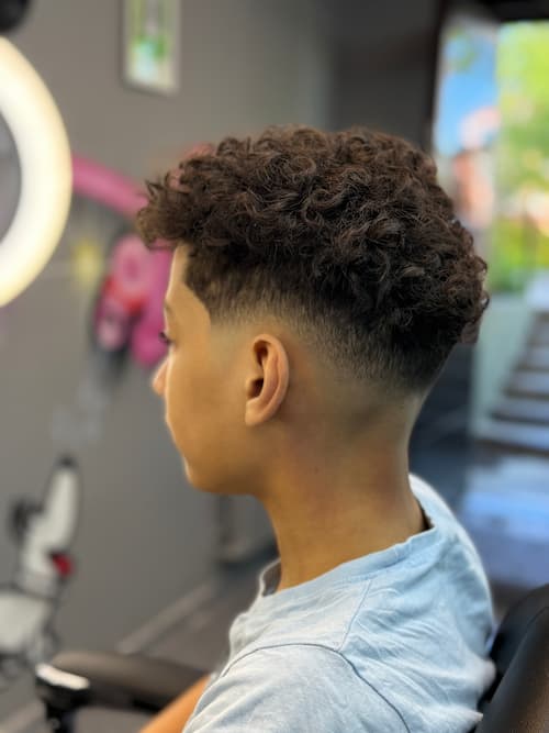 A client receiving a stylish haircut at StyleFocus